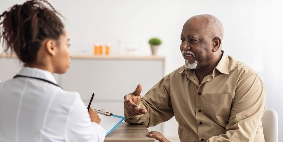 A doctor speaks with an older man.